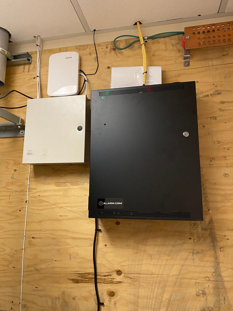 Alarm.com panel and networking equipment installed on wall by Onora Systems in Tucson