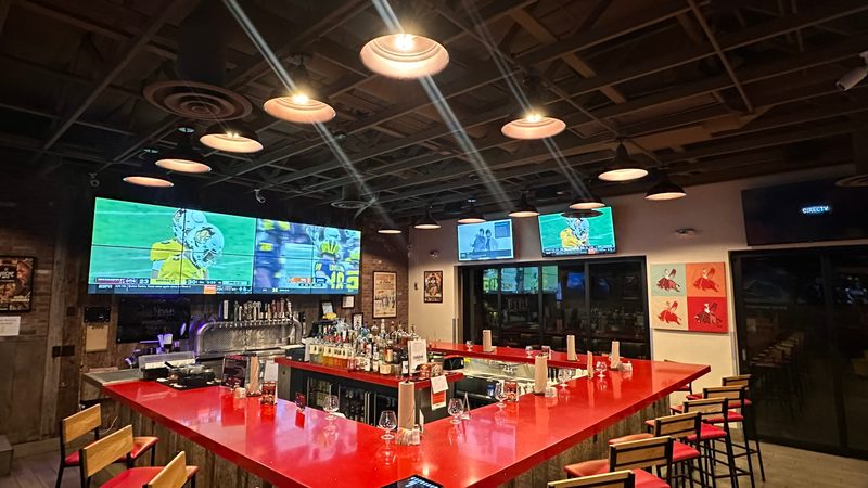 Commercial bar with multi-screen TV setup by Onora Systems