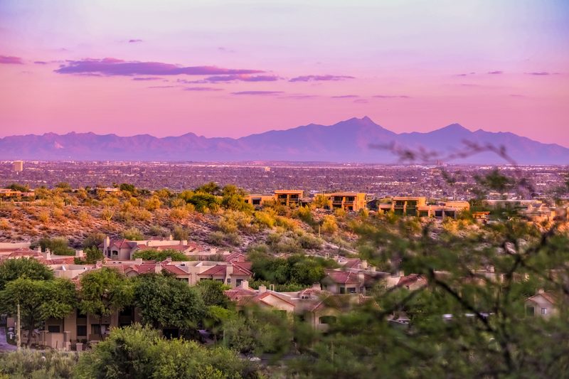 Tucson foothills home at twilight showing the intense desert sun and mountain views that demand motorized shading